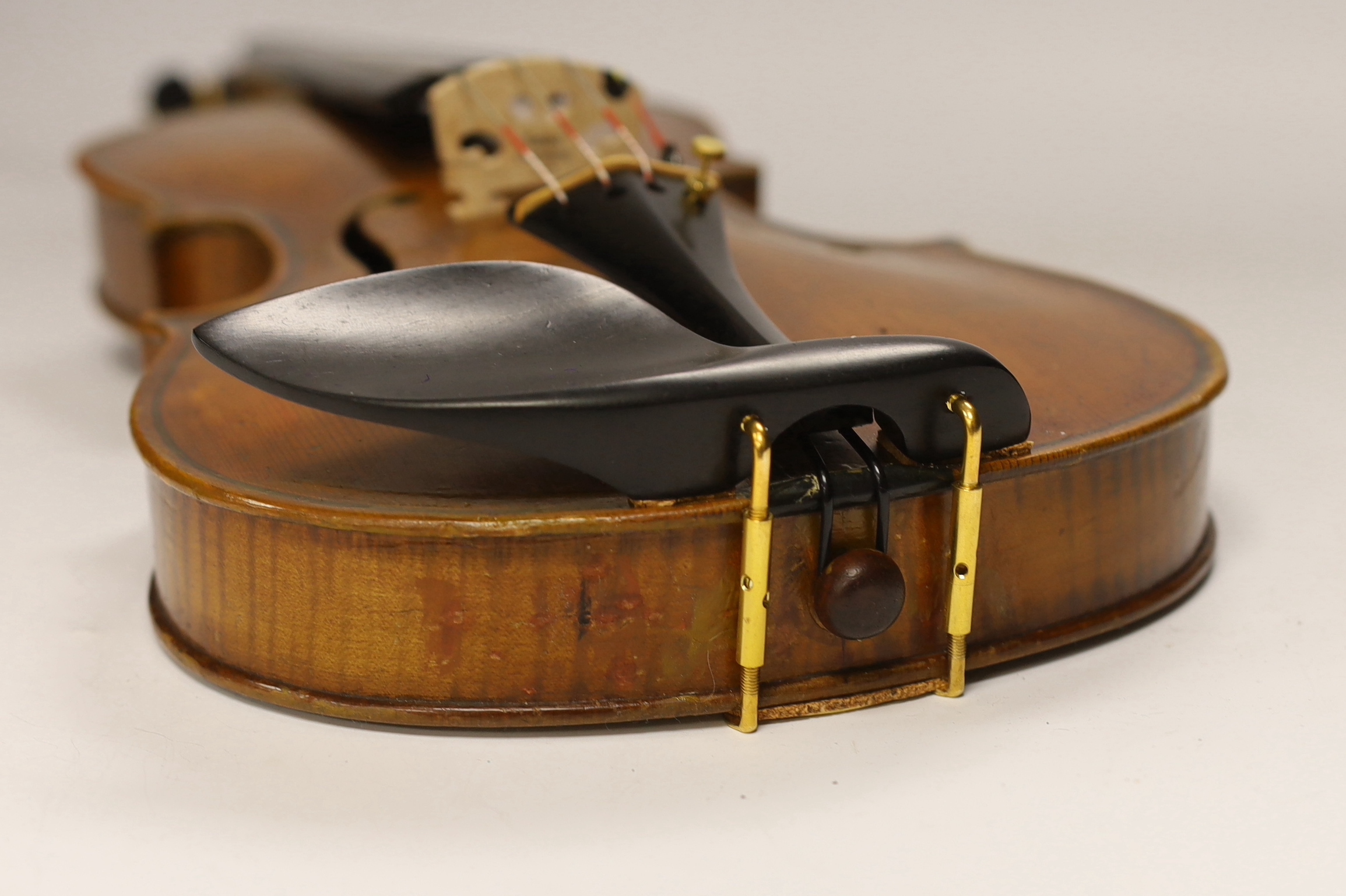 A late nineteenth century English violin by Hidalgo with a label inside the body showing a crown over Hidalgo, with a bow in an ebonised wooden case, body 36cm
